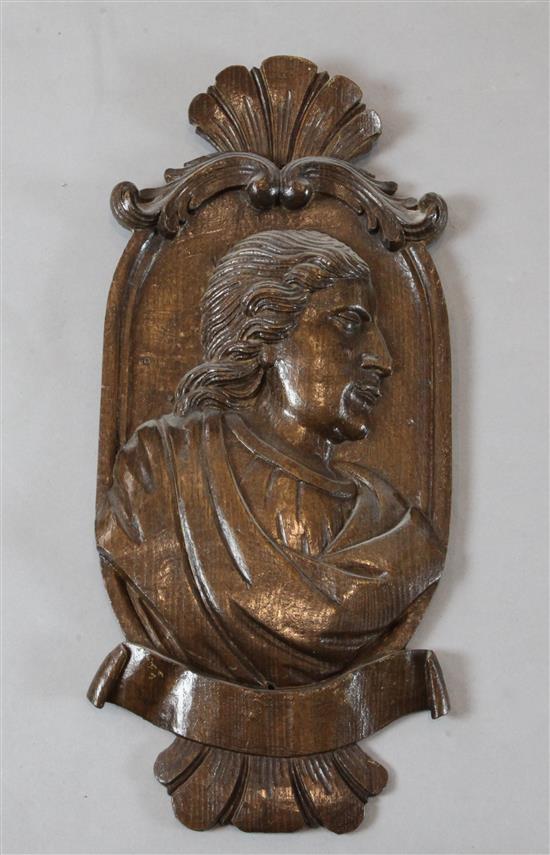 An 18th century oak carved portrait of a youth, 21 x 9.25in.